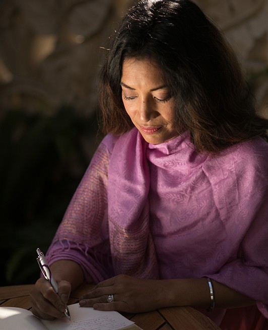 Dr. Carrie writing in a journal