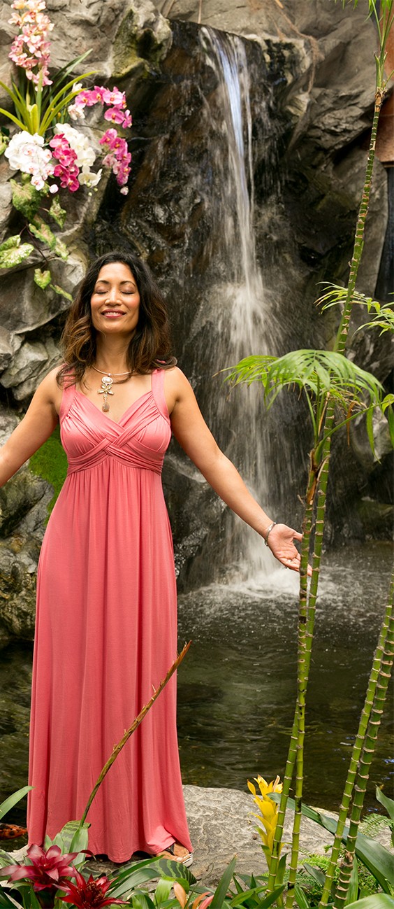 Dr. Carrie standing near a waterfall nature scene