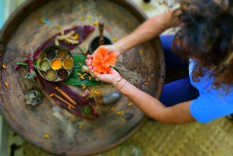 woman holds natural herbs