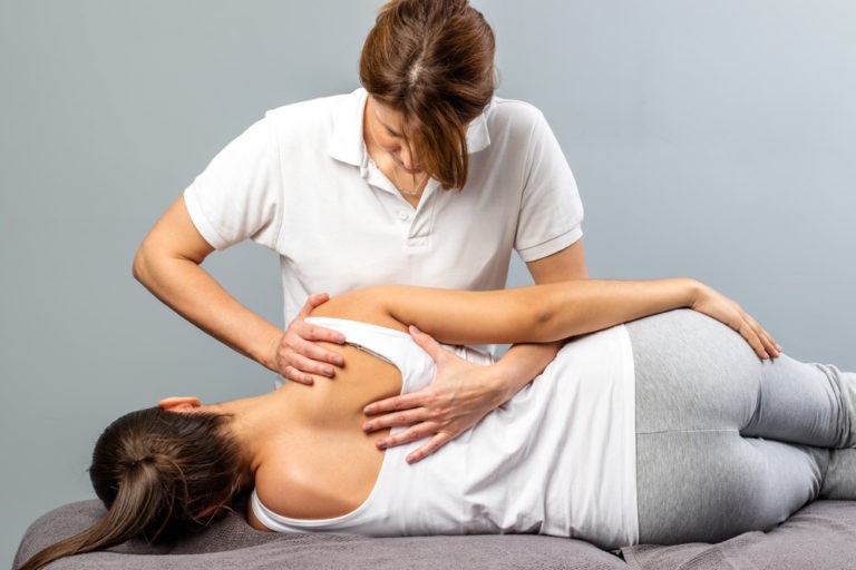 female osteopath works on the muscles of a woman